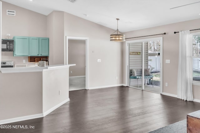 unfurnished dining area featuring dark wood-style floors, visible vents, baseboards, and lofted ceiling