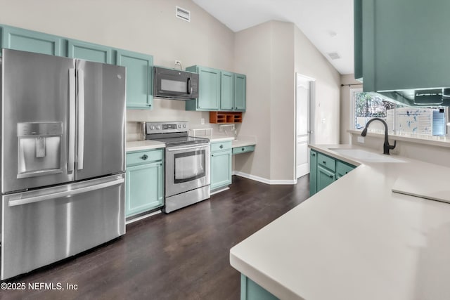 kitchen featuring visible vents, appliances with stainless steel finishes, light countertops, and a sink