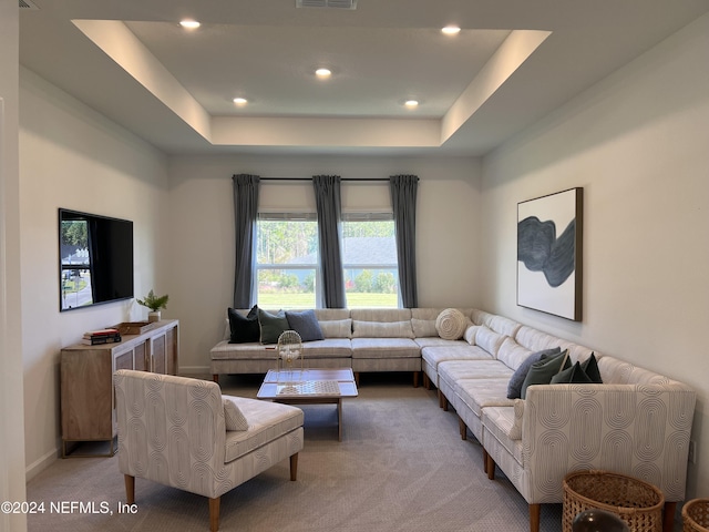 living room with recessed lighting, light carpet, visible vents, baseboards, and a raised ceiling