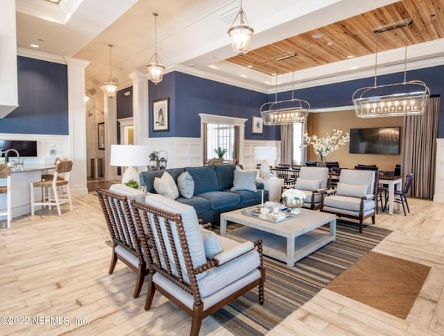 living room featuring a decorative wall, wood finished floors, wood ceiling, ornamental molding, and a raised ceiling