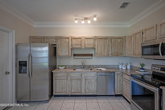 kitchen featuring visible vents, light stone counters, stainless steel appliances, crown molding, and a sink