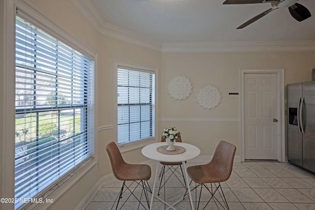 dining space featuring ceiling fan, crown molding, baseboards, and light tile patterned floors