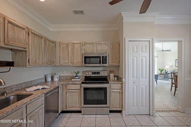 kitchen with visible vents, stainless steel appliances, a sink, and light brown cabinetry