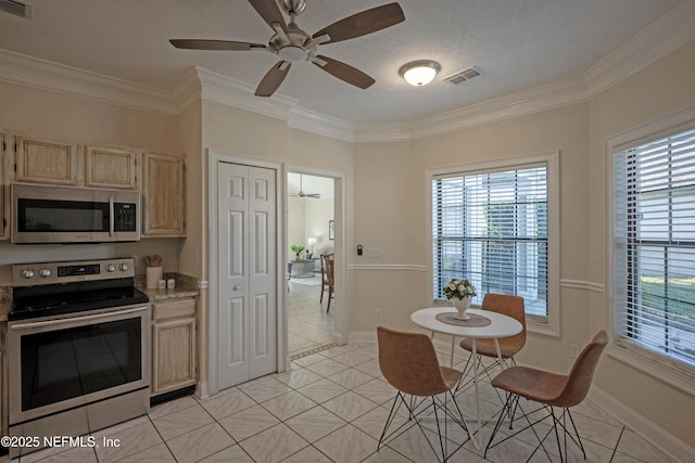 kitchen featuring light brown cabinets, visible vents, stainless steel appliances, and ornamental molding