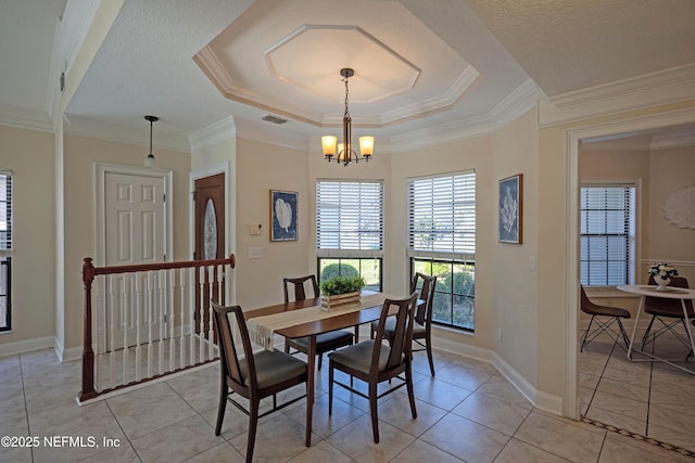 dining area featuring light tile patterned floors, ornamental molding, a raised ceiling, and a notable chandelier