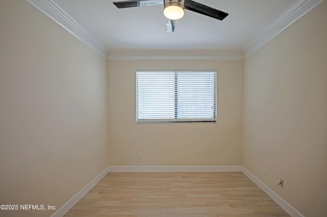 empty room featuring light wood finished floors, baseboards, ceiling fan, crown molding, and a textured ceiling