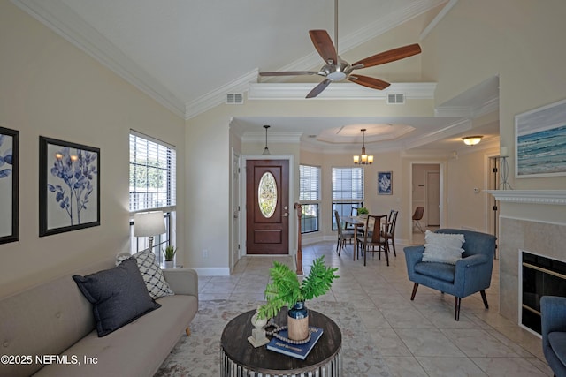 living area with light tile patterned flooring, a fireplace, visible vents, and crown molding