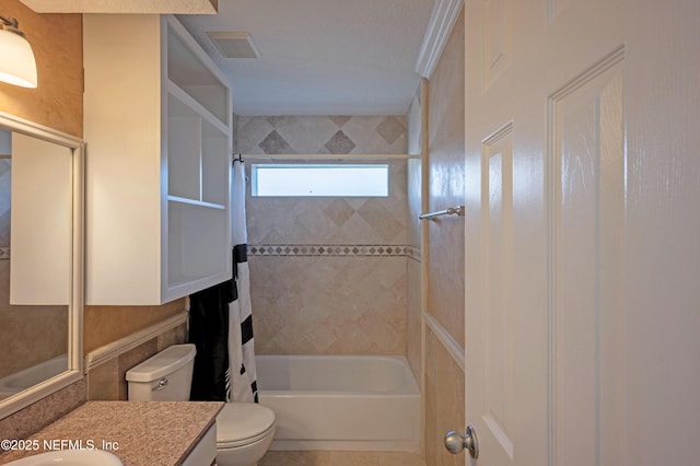 bathroom featuring shower / bath combo, visible vents, vanity, and toilet