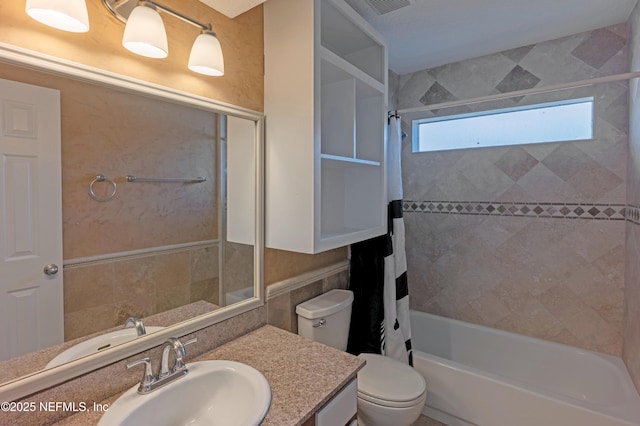 full bath featuring vanity, shower / bath combination with curtain, and toilet