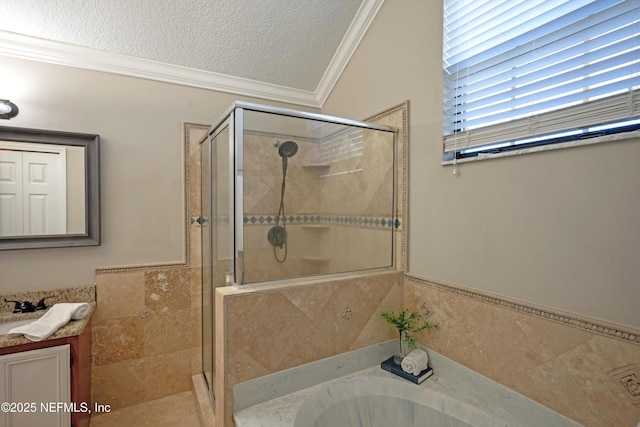 full bathroom with a textured ceiling, vanity, ornamental molding, a shower stall, and a bath