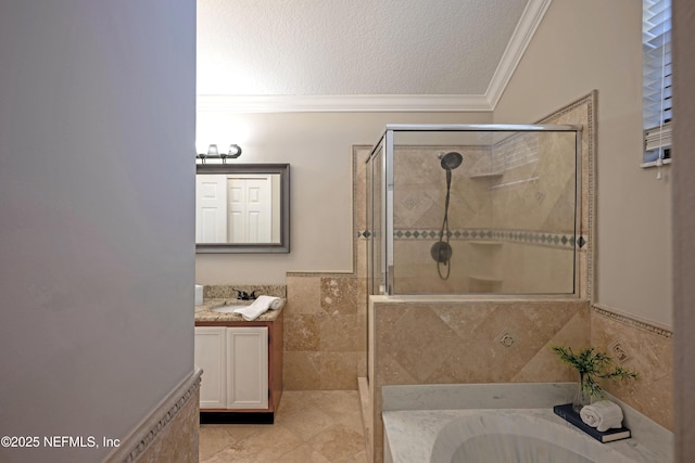 full bath featuring a garden tub, crown molding, a shower stall, a textured ceiling, and vanity