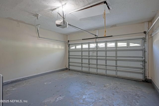 garage featuring a garage door opener and baseboards