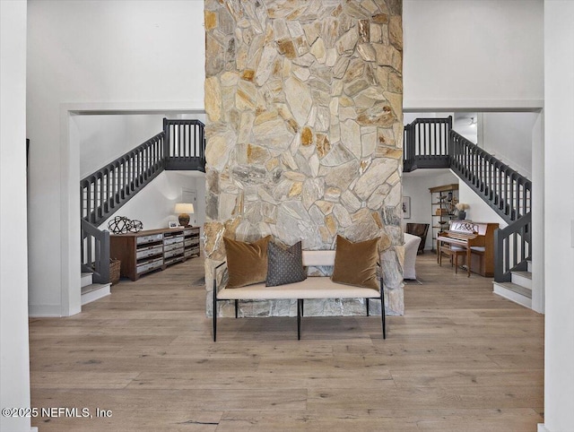 interior space featuring stairs, a high ceiling, and wood finished floors