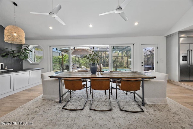 dining space featuring vaulted ceiling, recessed lighting, a ceiling fan, and light wood finished floors