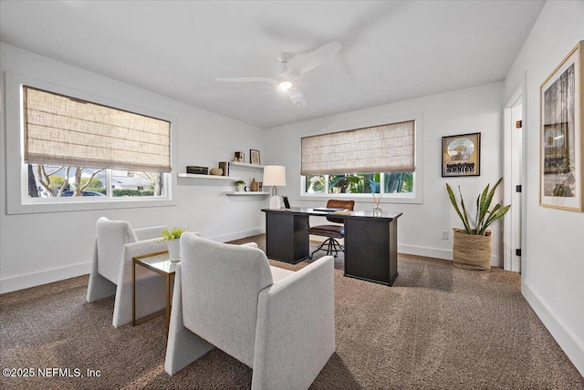 office with baseboards, dark carpet, and ceiling fan