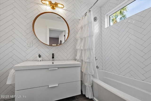 full bath with shower / bathtub combination with curtain, backsplash, tile walls, and vanity