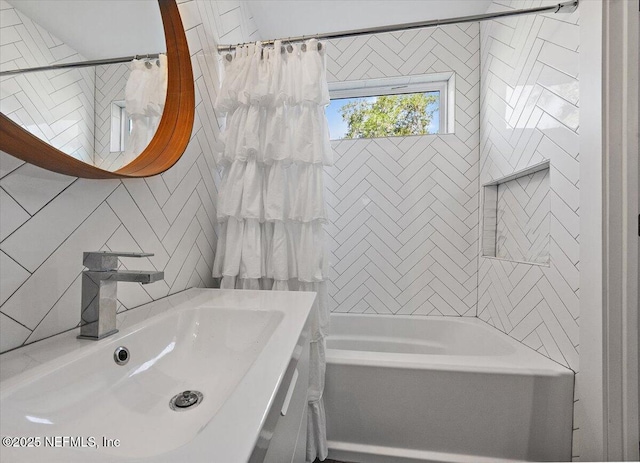 bathroom with shower / bath combo and a sink