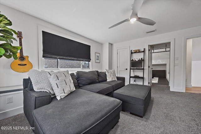 living room with visible vents, ceiling fan, and carpet flooring