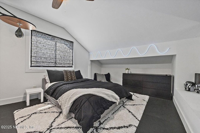 bedroom with baseboards, lofted ceiling, and ceiling fan