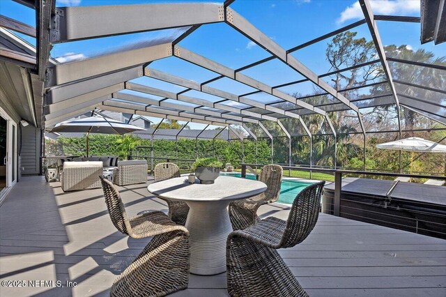 exterior space with outdoor lounge area, glass enclosure, and an outdoor pool