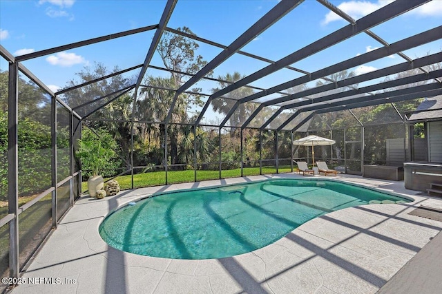 outdoor pool featuring a patio area and glass enclosure