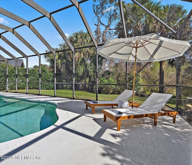 outdoor pool with glass enclosure and a patio