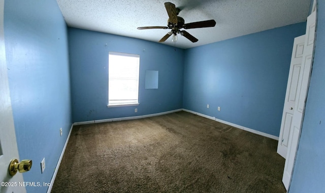 carpeted empty room featuring a ceiling fan, baseboards, and a textured ceiling