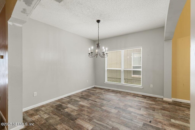 3925 Leatherwood Dr, Orange Park, FL 32065 - unfurnished dining area with wood finished floors, a textured ceiling, a chandelier, and baseboards