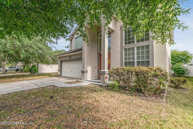 3925 Leatherwood Dr, Orange Park, FL 32065 - view of front facade featuring a garage, concrete driveway, stucco siding, and a front yard