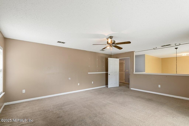 3925 Leatherwood Dr, Orange Park, FL 32065 - spare room featuring a ceiling fan, light carpet, baseboards, and a textured ceiling