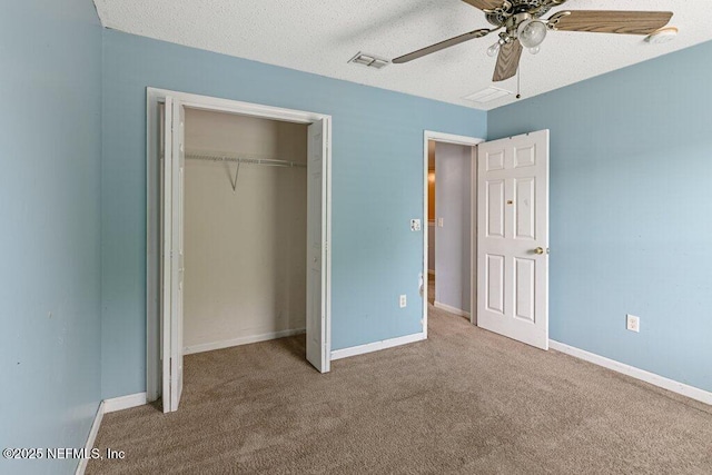 3925 Leatherwood Dr, Orange Park, FL 32065 - unfurnished bedroom with carpet floors, a closet, a ceiling fan, baseboards, and a textured ceiling