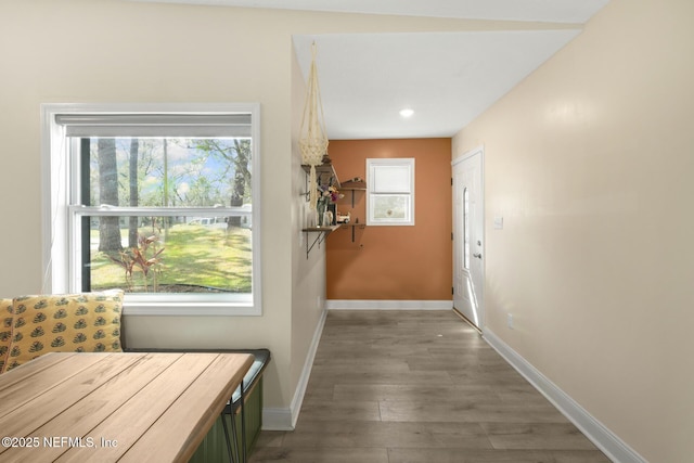 corridor featuring recessed lighting, baseboards, and wood finished floors