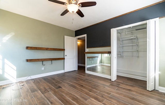 unfurnished bedroom with visible vents, a closet, baseboards, and wood finished floors