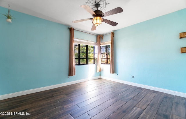 unfurnished room featuring ceiling fan, dark wood finished floors, and baseboards