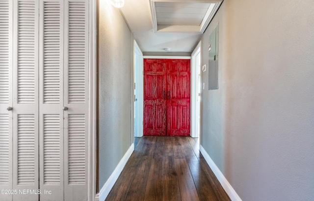 hallway featuring dark wood-style floors and baseboards