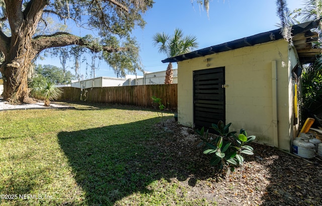 view of yard featuring an outdoor structure and a fenced backyard