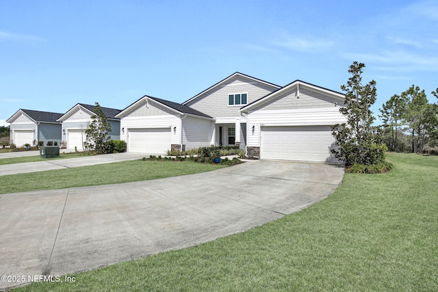 view of front of property with stone siding, driveway, an attached garage, and a front yard