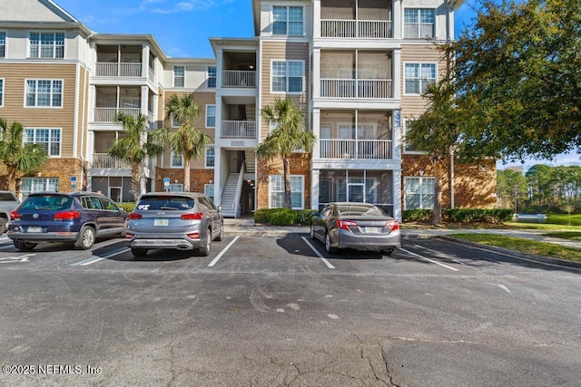 view of building exterior with uncovered parking