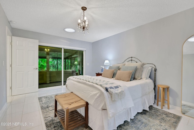 bedroom featuring access to outside, a textured ceiling, a chandelier, tile patterned floors, and baseboards