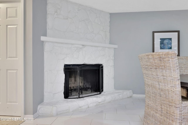 detailed view of a stone fireplace and baseboards