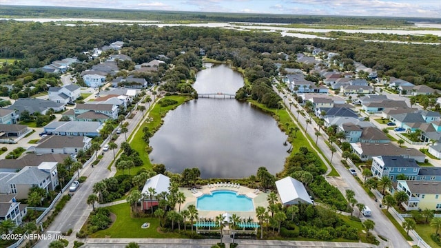 drone / aerial view with a water view and a residential view