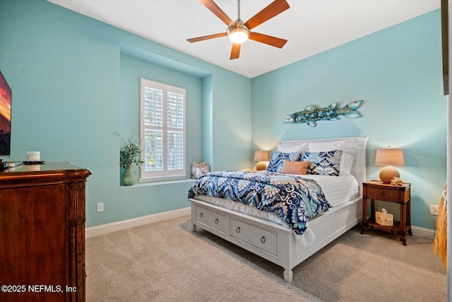 carpeted bedroom with a ceiling fan and baseboards