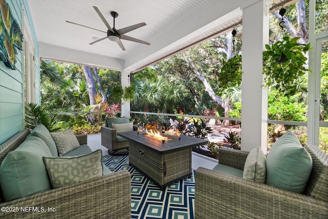 view of patio / terrace with ceiling fan and an outdoor living space with a fire pit