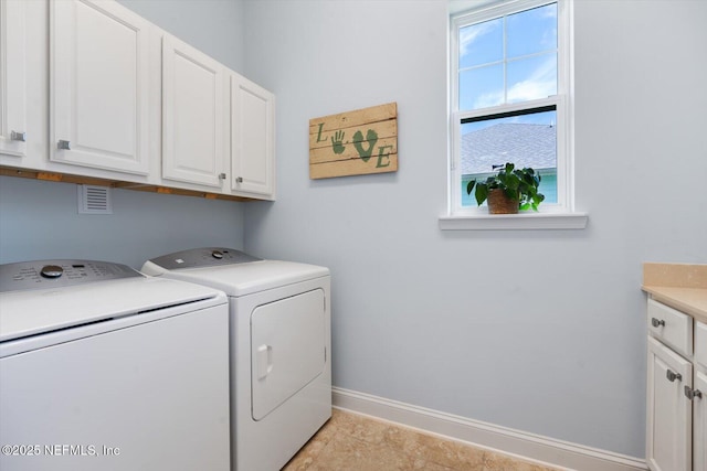 washroom with cabinet space, baseboards, and separate washer and dryer