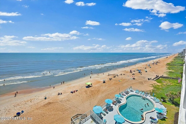 aerial view with a water view and a beach view