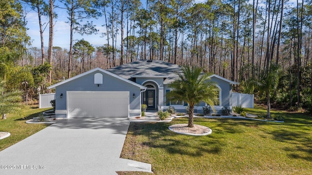 view of front of home featuring an attached garage, fence, concrete driveway, stucco siding, and a front yard