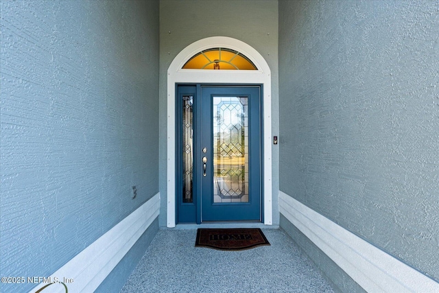 property entrance with stucco siding