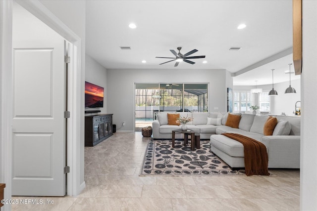 living area featuring recessed lighting, visible vents, ceiling fan, and baseboards