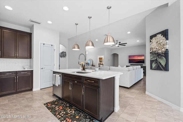 kitchen with light countertops, visible vents, dark brown cabinetry, a sink, and dishwasher