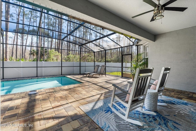 view of pool with a ceiling fan, a fenced in pool, a patio, a lanai, and fence